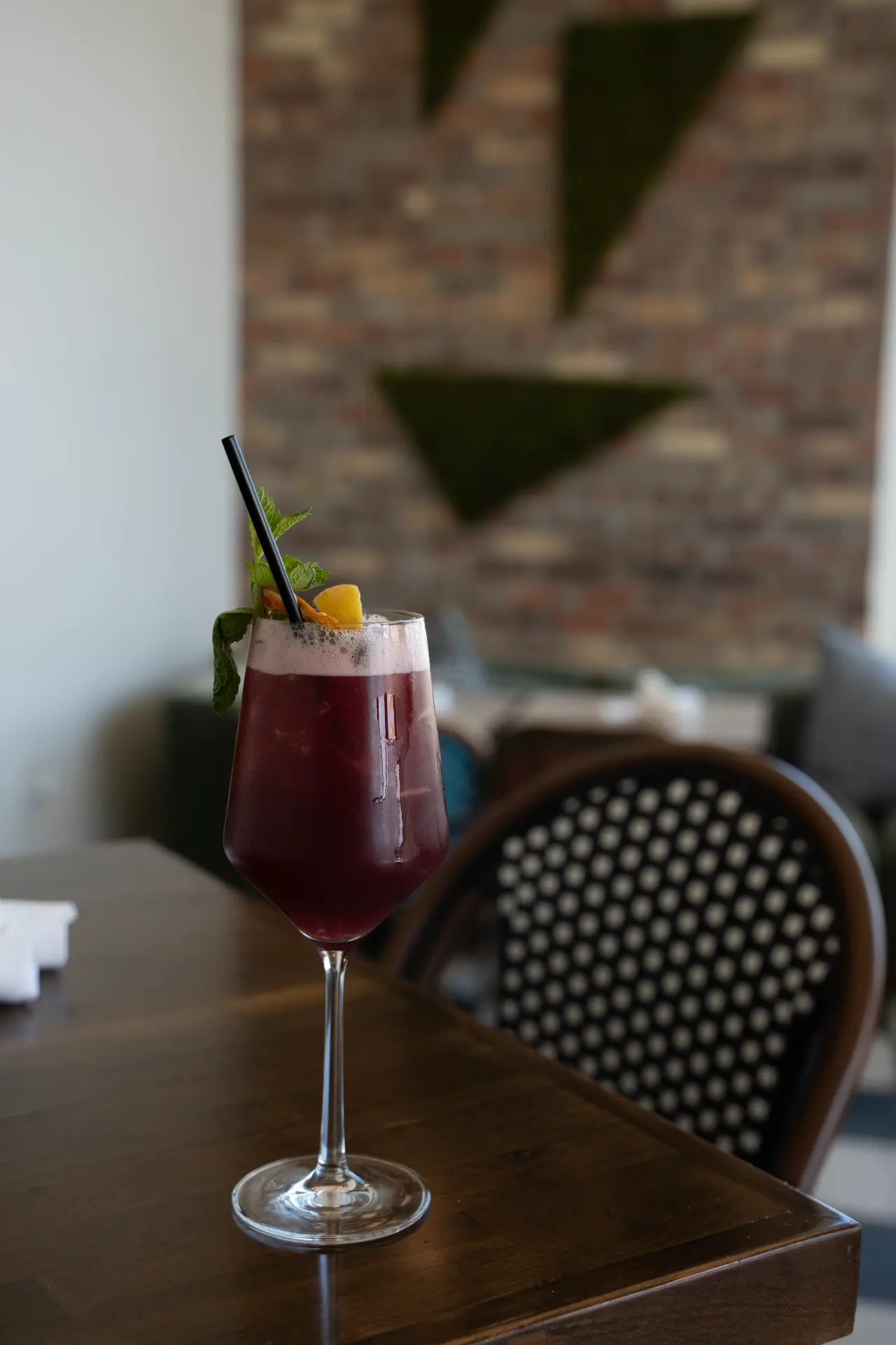 Dark red cocktail with mint at Candle Bar
